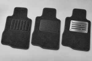 Three automotive carpet driver mats with carpet, flexible polymer, and metal heel pads