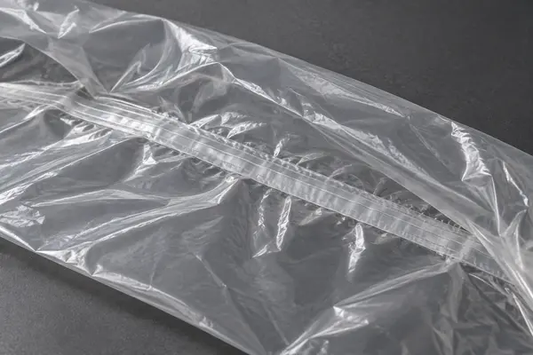 Close view of a uniform heat-sealed seam in a transparent disposable plastic full-car cover