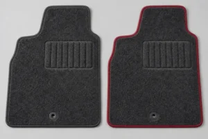 Two charcoal wool automotive floor mats comparing matched charcoal binding with contrasting red binding